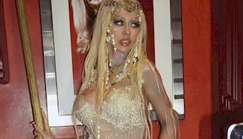 Cropped view of Christina Aguilera looking off to the side while wearing a mermaid costume