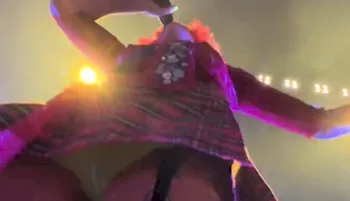 Looking straight up a woman's skirt who is on stage