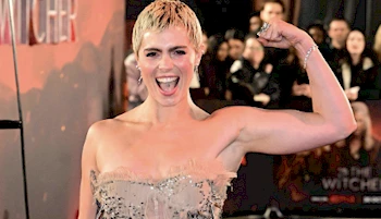 Cropped view of Joelle Rae flexing her muscles on the red carpet