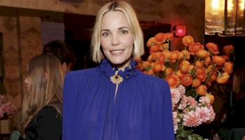 Cropped version of a woman smiling at a dinner event
