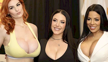 Close up of three women with large breasts showing cleavage