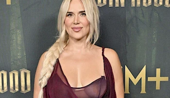 Close of of woman wearing a semi-sheer dress on the red carpet