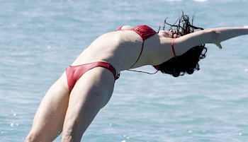 Woman in a bikini diving backwards