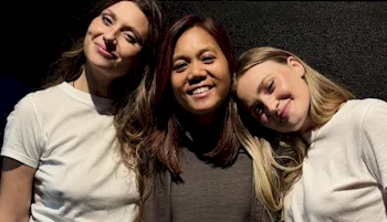 Cropped version of three women posing close together