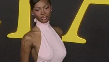 Close up of black woman posing to the side in a pink dress
