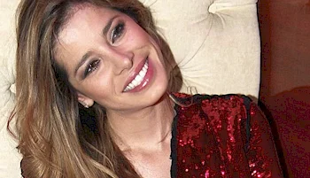 Close up of woman cocking her head with a smile on her face