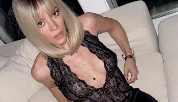 Close up of Lily Allen sitting back in a sofa