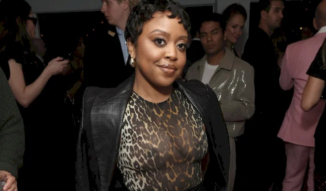 Cropped close up of black actress wearing a sheer top at a party
