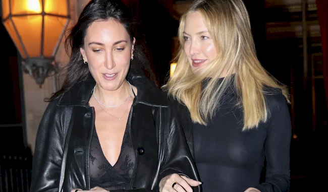 Two ladies leaving a restaurant at night