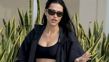 Close up of woman wearing sunglasses and sports top