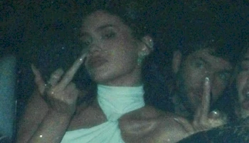 Close up of Kylie Jenner flipping the bird inside a car