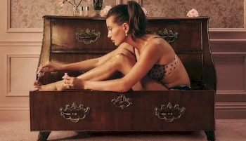 Side view of model sitting in a big trunk