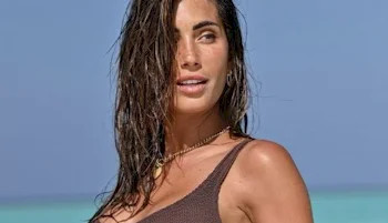 Close up of smiling woman with wet hair at a beach
