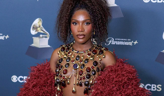 Close up of a topless black woman wearing a big necklace