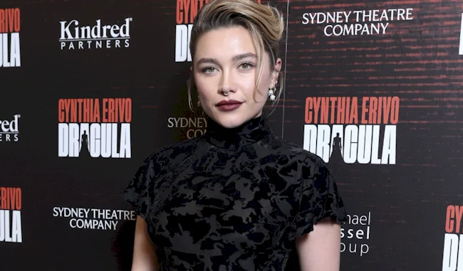 Beautiful actress looking directly into the camera at a premiere