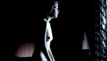 Side view of nude Rose Byrne sitting on top of a man in a dark room