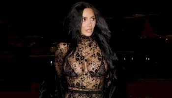 Frontal of Kim Kardashian wearing a lace dress and bra