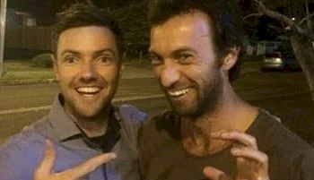 Two ugly guys sharing a laugh while posing for a selfie