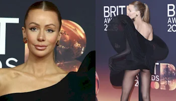 A woman with slicked-back hair wears a dramatic, asymmetrical black dress on the red carpet at the BRIT Awards 2024, posing both facing forward and with her back turned.