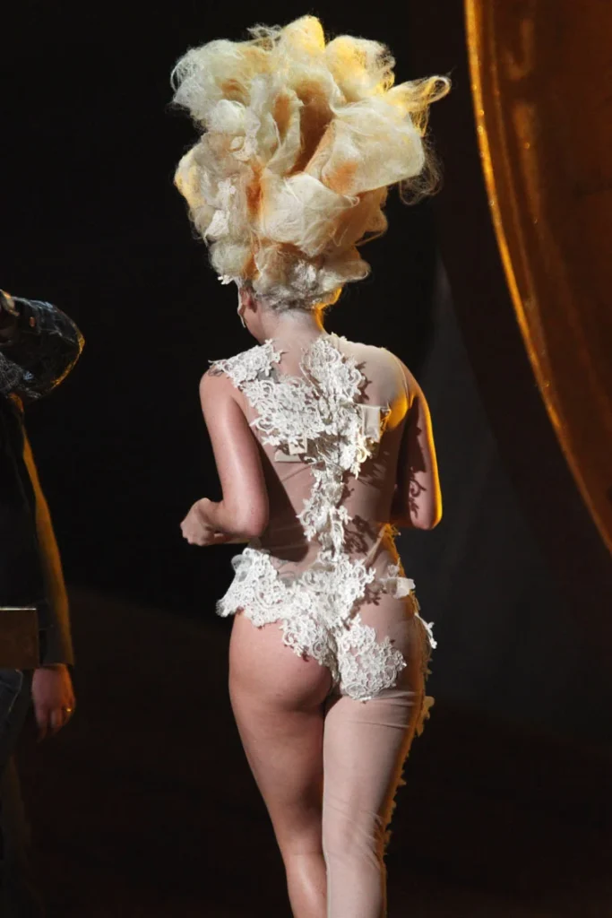 Backside of Lady Gaga in revealing costume walking away on a stage