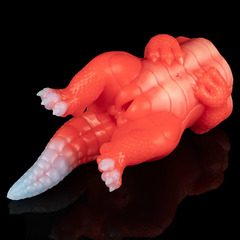 A sex toy for men that is in the shape of a dragon against a black background.