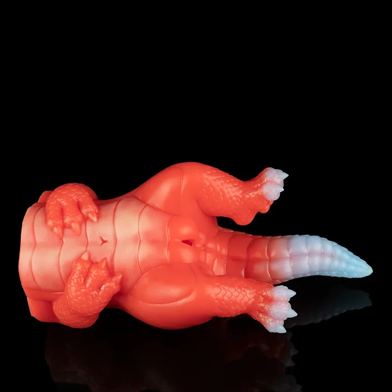A sex toy for men that is in the shape of a dragon against a black background.