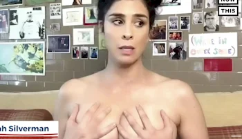 Sarah Silverman topless and grabbing her breasts while glancing to the side.