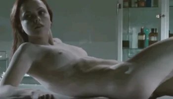 Nude Christina Ricci waking up in a morgue. She is on her back and resting on her elbows.