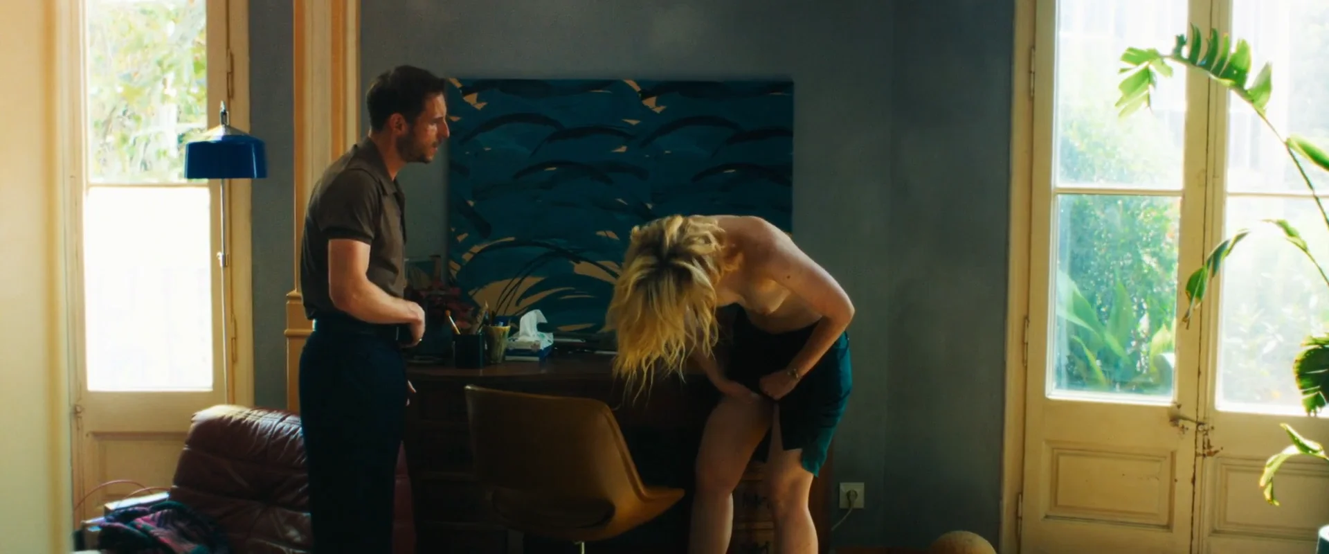 Elle-Fanning-Topless-Rosebush-Pruning6 Elle Fanning topless and bent over, appearing to clean her crotch in front of a desk. A man stands next to her.