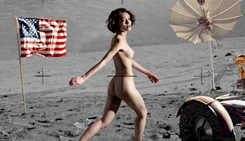 A nude woman walks on a gray, moon-like surface with an American flag, a vintage umbrella, and part of a machine visible in the background.