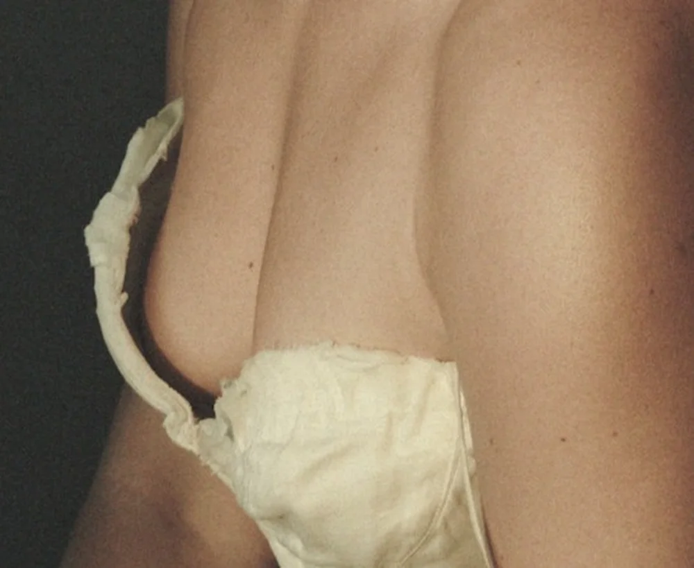 FlorencePughNetflixTudumPic2 A close-up view of a woman's chest wearing a beige, structured strapless top.