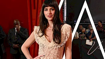 Dakota Johnson posing on a red carpet.
